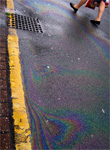 Motor oil leaked from individual vehicles - or outright dumped by homeowners and commercial garages - constitutes a significant chunk of storm water runoff, the fallen precipitation that runs off of roads and parking lots and inevitably finds its way into local water bodies. - Image by Kendrack, courtesy Flickr." 